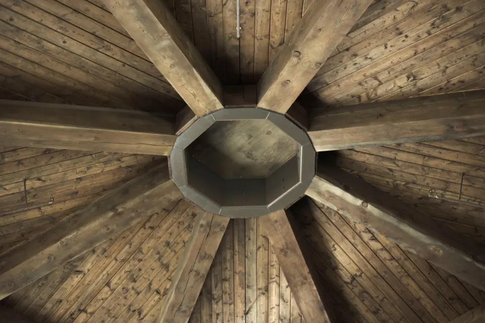 A boarded timber ceiling radiating from an octagonal centre